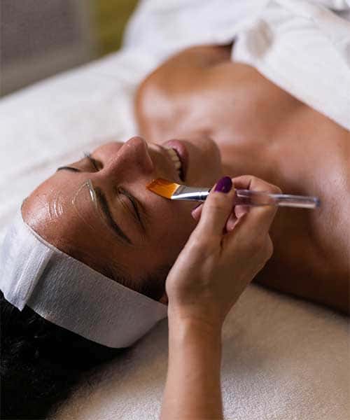 Esthetician treating acne-prone skin